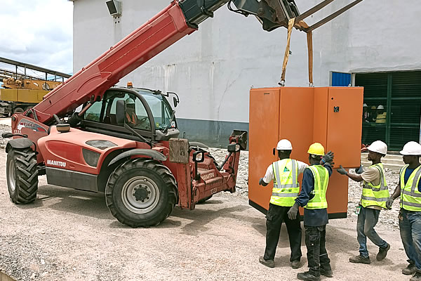 Industrial team handling machinery with PPE on site